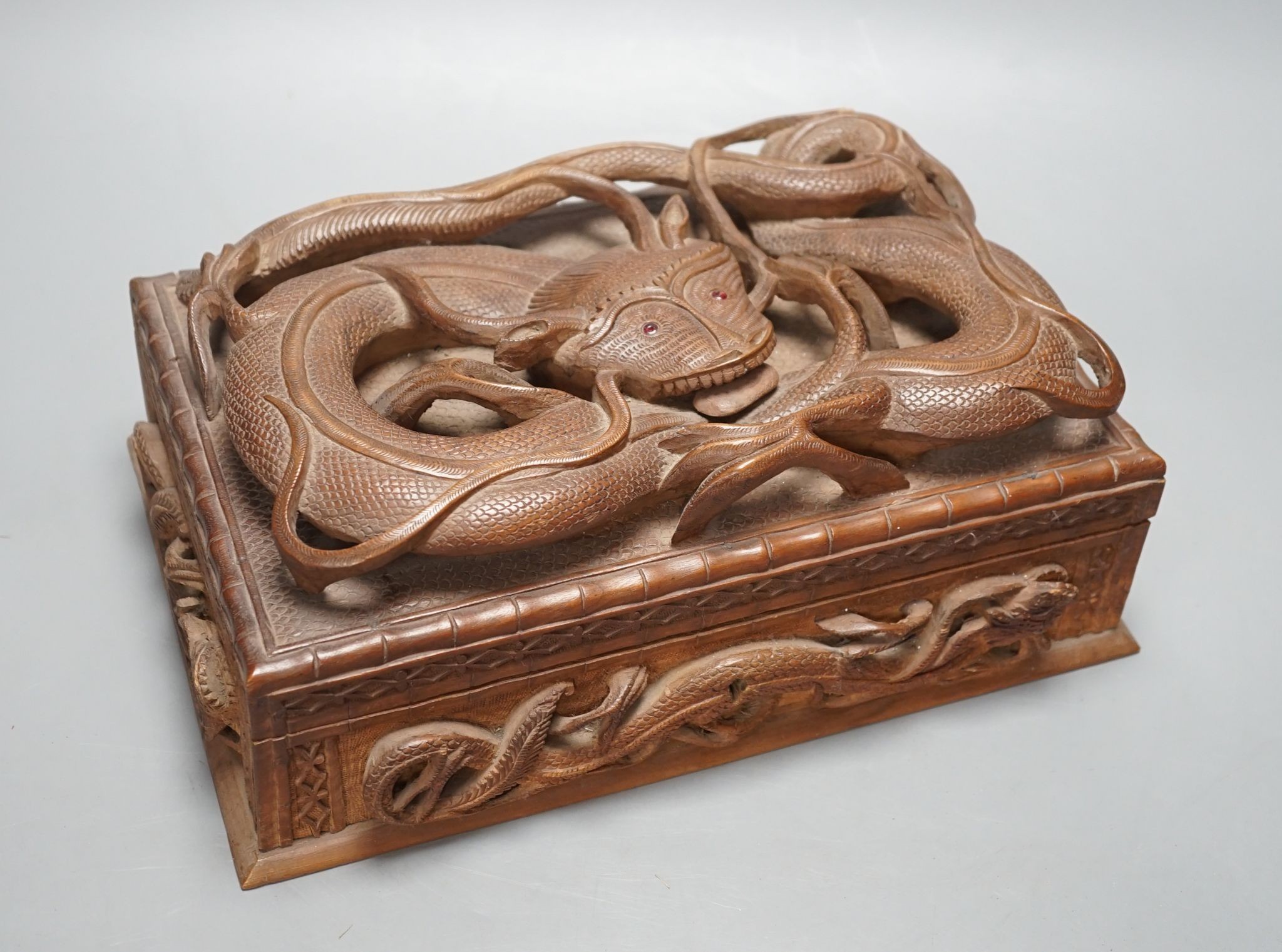 A Burmese carved wood 'Dragon' box, 31cm wide